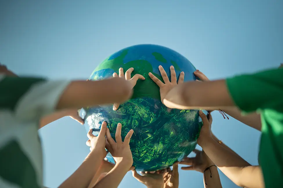 Detail photo of hands holding up a globe